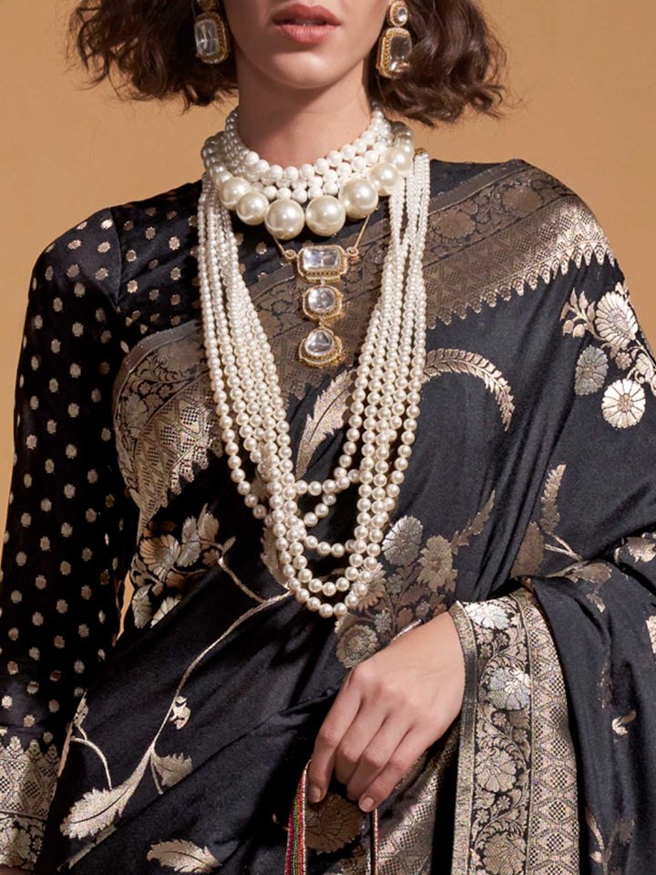 The soft, sheer fall of georgette is visible as it cascades over the shoulder in a natural pleated arrangement, highlighting its lightness and fluidity