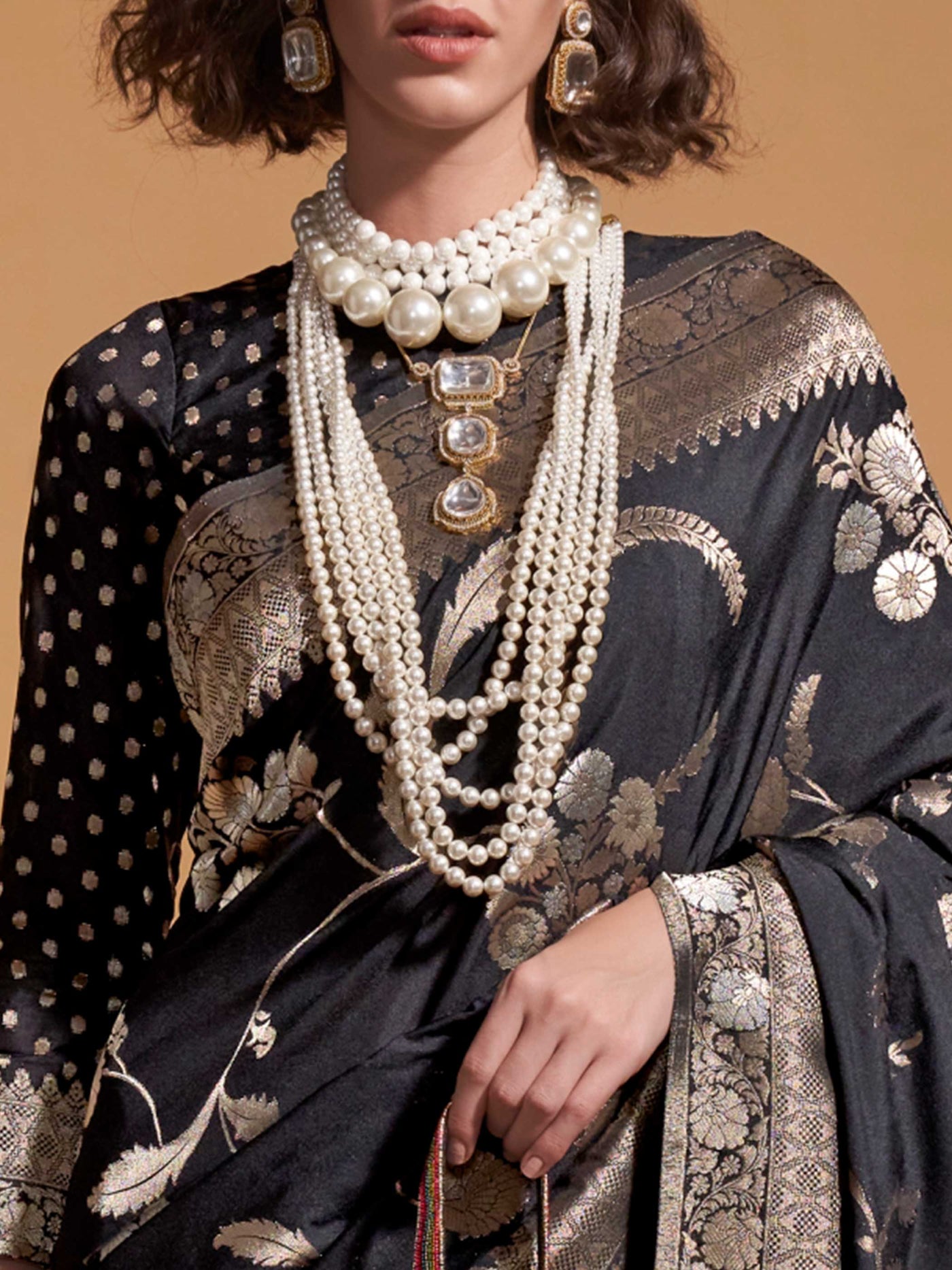 The soft, sheer fall of georgette is visible as it cascades over the shoulder in a natural pleated arrangement, highlighting its lightness and fluidity