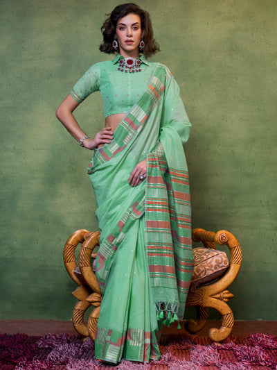 Mint green cotton spun saree with multicolor woven pallu and floral design, perfect for summer festivities. Soft mint green saree with checkered border and handwoven detailing, styled for cultural events.