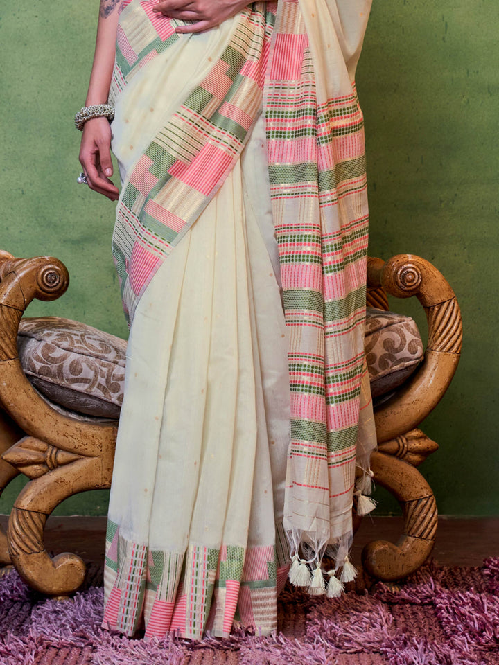 Ivory–Pink spun cotton drape with lightweight texture and floral borders for ceremonies. Ivory–Pink ethnic saree in cotton fabric, perfect for pooja, haldi or cultural meetups.