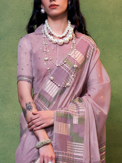 Subtle Dusty Mauve–Olive cotton saree styled with check borders and artisan-inspired floral pallu. Dusty Mauve–Olive soft spun saree with handwoven detailing across pallu and border, festive ready.