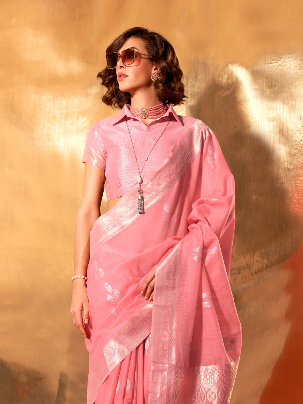 Elegant pastel pink linen saree with silver threadwork for pooja or engagement ceremonies. Linen silk blend rose pink saree with silver border detailing and festive pallu styling.