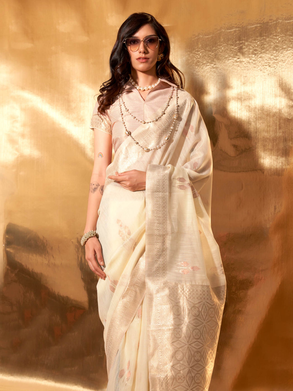 Ivory–Beige festive-ready saree with breathable fall and floral border accents. Chic pastel linen saree in Ivory–Beige with floral woven design for daytime events.