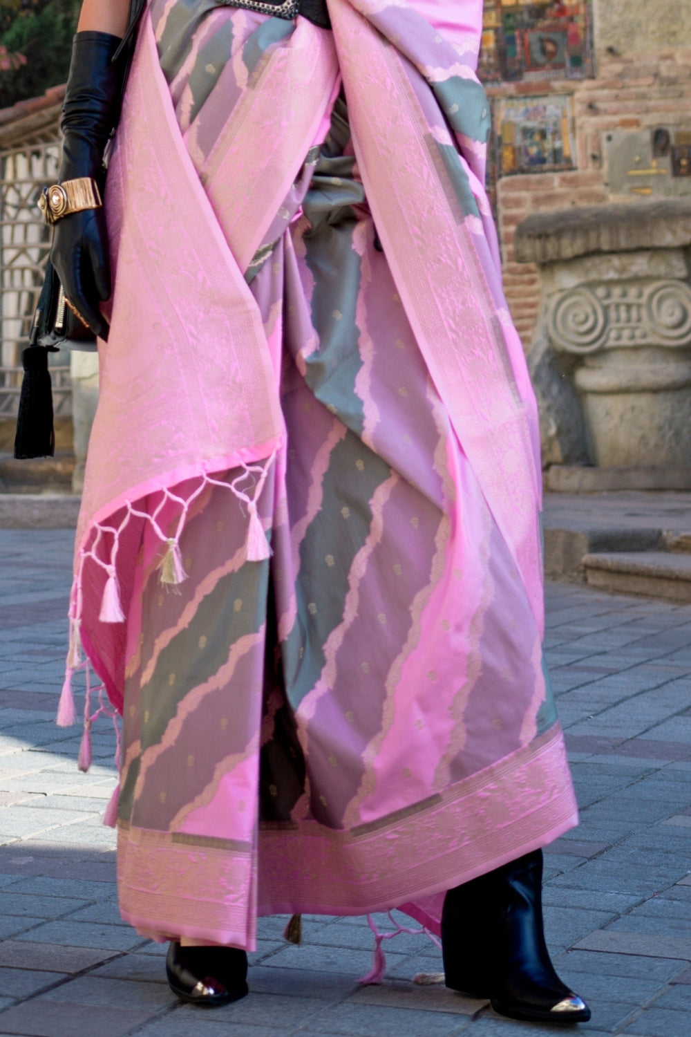 Dusty Pink and Olive Kimbus saree in rangkaat katan silk, designed with wave-striped motifs and a dramatic tassel pallu. Best styled for party-wear and fashion-forward fashion week celebrations. This image captures the back drape focus revealing pallu finesse and motif richness, ideal for visualizing festive elegance, designer appeal, and modern styling inspiration. Perfect for online shoppers seeking detailed previews before purchase, enhancing saree visual merchandising and SEO-rich product display strate
