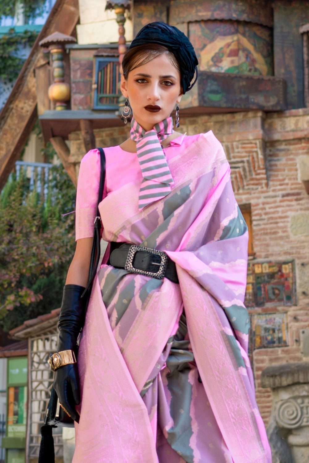 Dusty Pink and Olive Kimbus saree in rangkaat katan silk, designed with wave-striped motifs and a dramatic tassel pallu. Best styled for party-wear and fashion-forward fashion week celebrations. This image captures the side angle view showcasing blouse styling and zari border detail, ideal for visualizing festive elegance, designer appeal, and modern styling inspiration. Perfect for online shoppers seeking detailed previews before purchase, enhancing saree visual merchandising and SEO-rich product display s