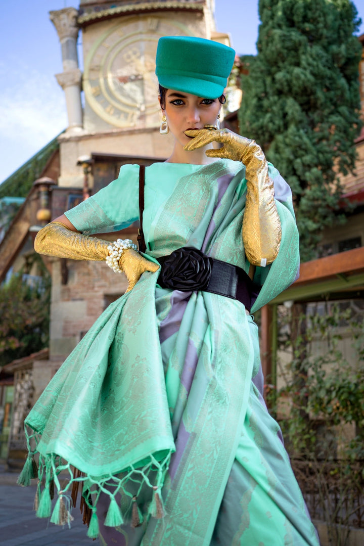 Mint and Mauve Kimbus saree in rangkaat katan silk, designed with wave-striped motifs and a dramatic tassel pallu. Best styled for sangeet and fashion-forward fusion ceremony celebrations. This image captures the zoomed texture view illustrating fabric weave and print clarity, ideal for visualizing festive elegance, designer appeal, and modern styling inspiration. Perfect for online shoppers seeking detailed previews before purchase, enhancing saree visual merchandising and SEO-rich product display strategy