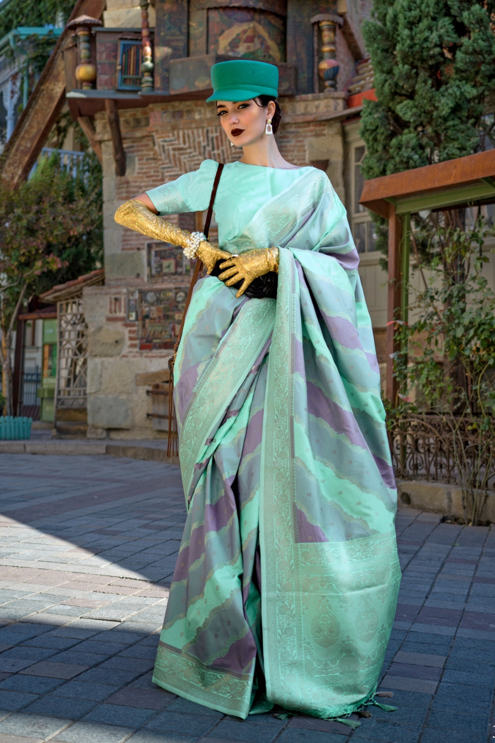 Mint and Mauve Kimbus saree in rangkaat katan silk, designed with wave-striped motifs and a dramatic tassel pallu. Best styled for sangeet and fashion-forward fusion ceremony celebrations. This image captures the front drape view highlighting pallu fall and pleats alignment, ideal for visualizing festive elegance, designer appeal, and modern styling inspiration. Perfect for online shoppers seeking detailed previews before purchase, enhancing saree visual merchandising and SEO-rich product display strategy. 