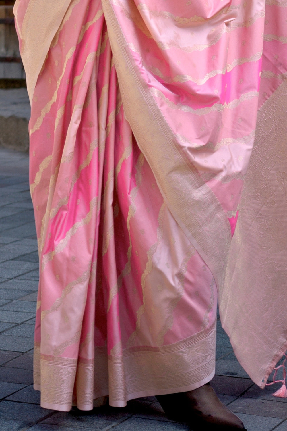 Peach and Rosy Pink Kimbus saree in rangkaat katan silk, designed with wave-striped motifs and a dramatic tassel pallu. Best styled for festive season and fashion-forward wedding morning celebrations. This image captures the back drape focus revealing pallu finesse and motif richness, ideal for visualizing festive elegance, designer appeal, and modern styling inspiration. Perfect for online shoppers seeking detailed previews before purchase, enhancing saree visual merchandising and SEO-rich product display 