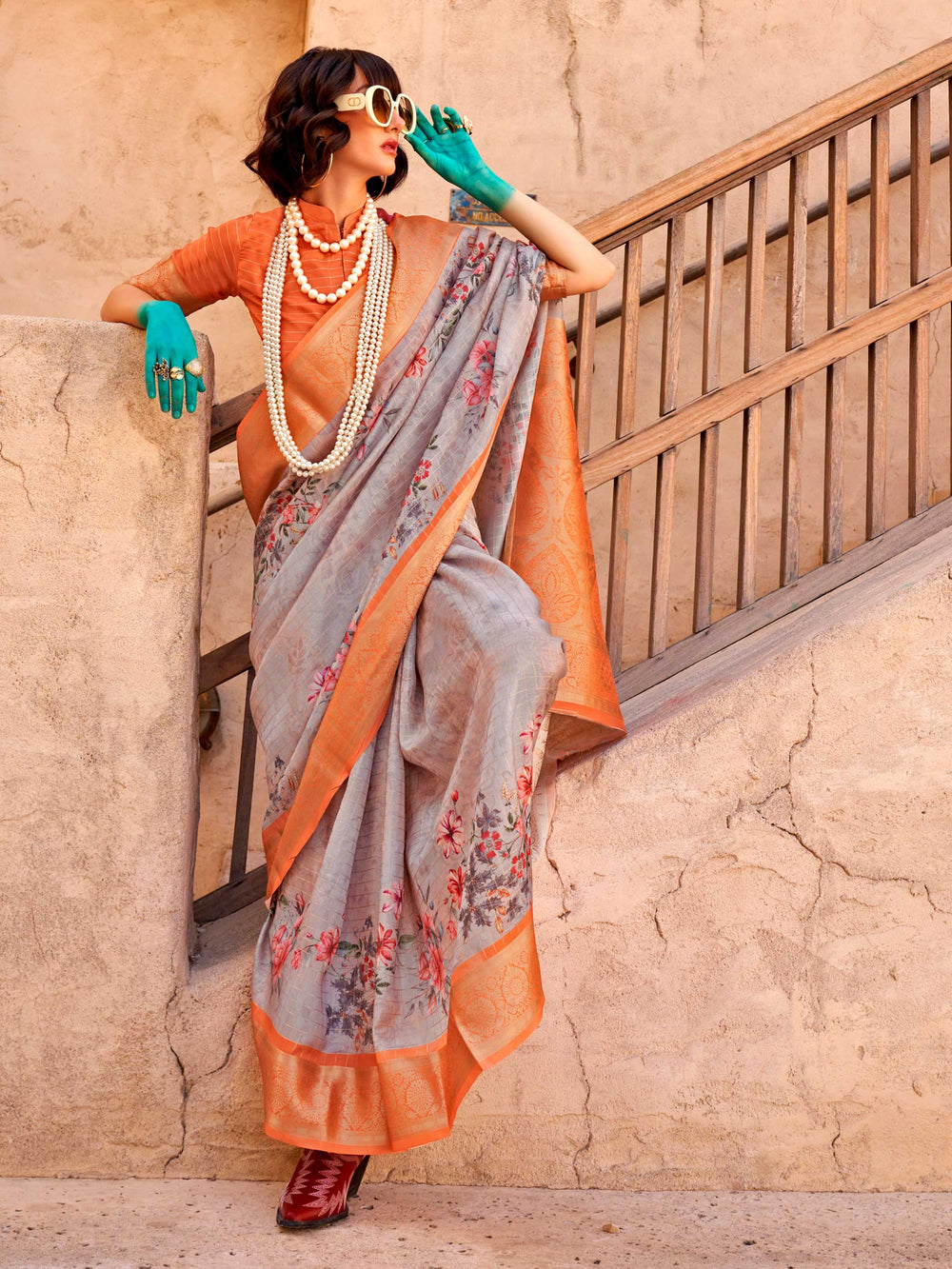 This Soft Grey–Burnt Orange FeatherSoft saree features stunning printed floral work with floral detailing and grid textures, ideal for festive evenings and cocktail-ready styling. Designed for lightweight elegance and statement draping. SKU 376002. This Soft Grey–Burnt Orange FeatherSoft saree features stunning printed floral work with floral detailing and grid textures, ideal for festive evenings and cocktail-ready styling. Designed for lightweight elegance and statement draping. SKU 376002.