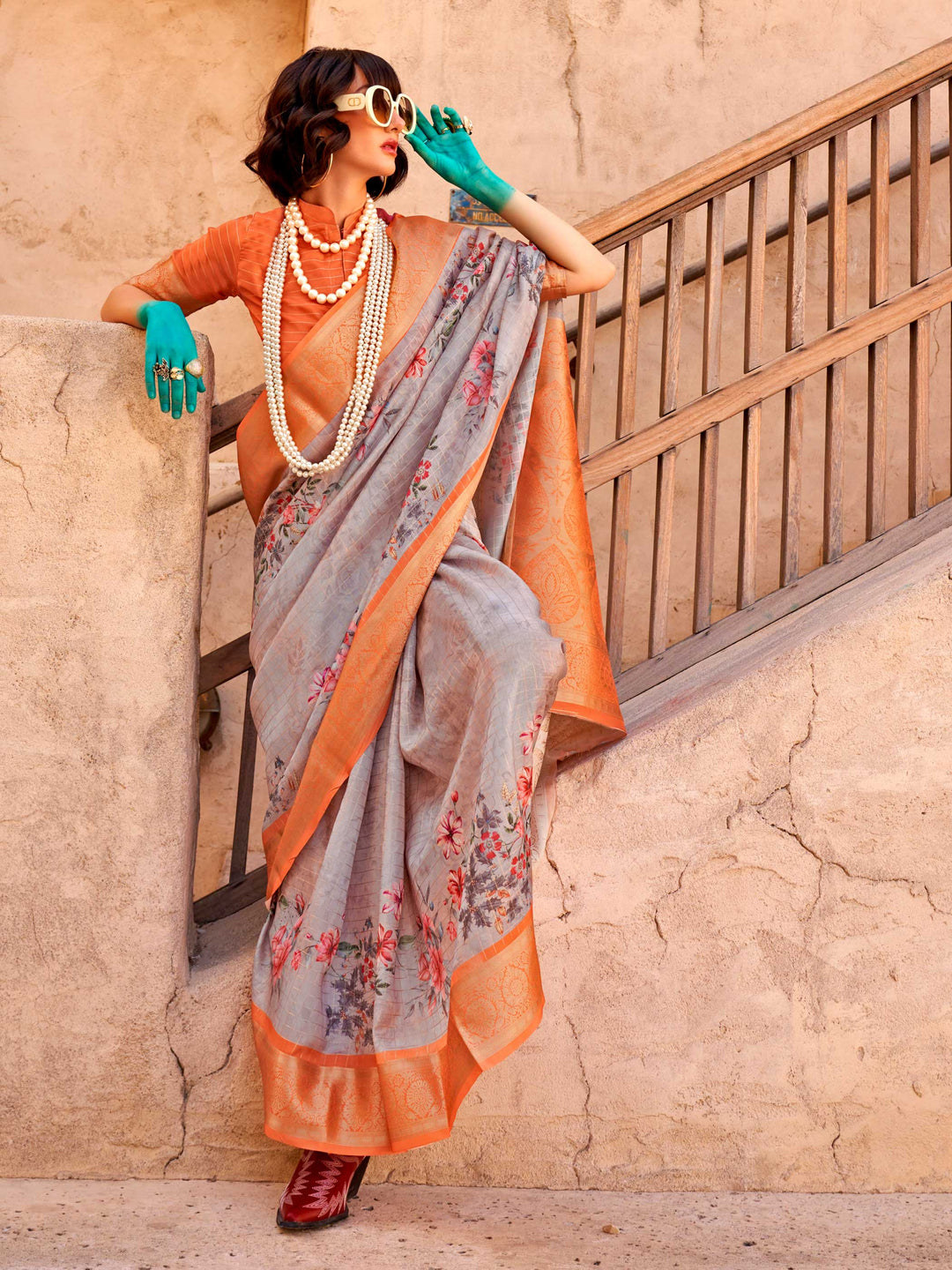 This Soft Grey–Burnt Orange FeatherSoft saree features stunning printed floral work with floral detailing and grid textures, ideal for festive evenings and cocktail-ready styling. Designed for lightweight elegance and statement draping. SKU 376002. This Soft Grey–Burnt Orange FeatherSoft saree features stunning printed floral work with floral detailing and grid textures, ideal for festive evenings and cocktail-ready styling. Designed for lightweight elegance and statement draping. SKU 376002.