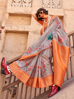 This Soft Grey–Burnt Orange FeatherSoft saree features stunning printed floral work with floral detailing and grid textures, ideal for festive evenings and cocktail-ready styling. Designed for lightweight elegance and statement draping. SKU 376002. This Soft Grey–Burnt Orange FeatherSoft saree features stunning printed floral work with floral detailing and grid textures, ideal for festive evenings and cocktail-ready styling. Designed for lightweight elegance and statement draping. SKU 376002.