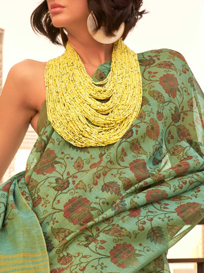Sea Green and Golden zari tissue saree with printed floral motifs and zari pallu This image captures the zoomed texture view illustrating fabric weave and print clarity, ideal for visualizing festive elegance, designer appeal, and modern styling inspiration. Perfect for online shoppers seeking detailed previews before purchase, enhancing saree visual merchandising and SEO-rich product display strategy.                                                                                                           