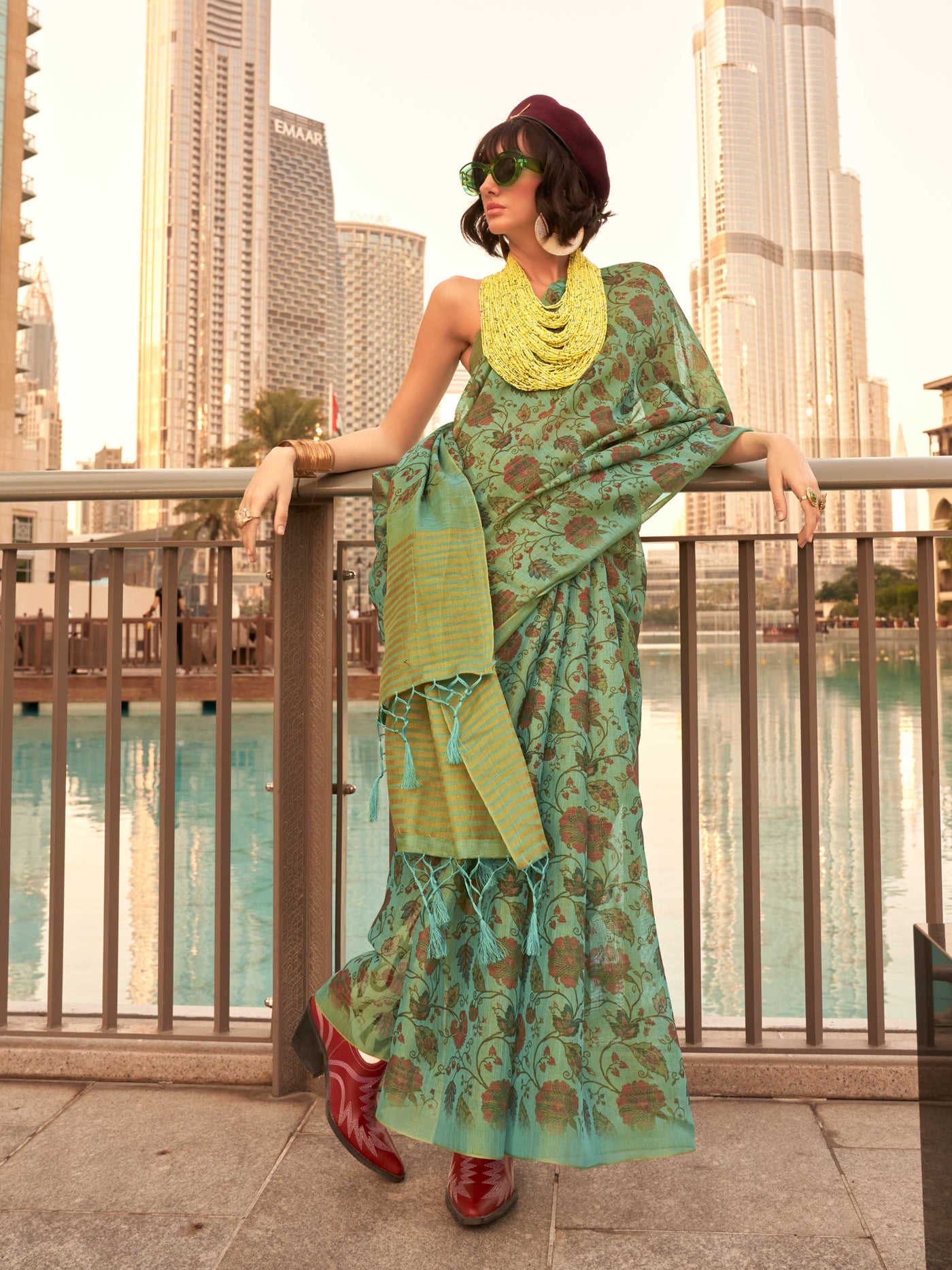 Sea Green and Golden zari tissue saree with printed floral motifs and zari pallu This image captures the front drape view highlighting pallu fall and pleats alignment, ideal for visualizing festive elegance, designer appeal, and modern styling inspiration. Perfect for online shoppers seeking detailed previews before purchase, enhancing saree visual merchandising and SEO-rich product display strategy.                                                                                                             