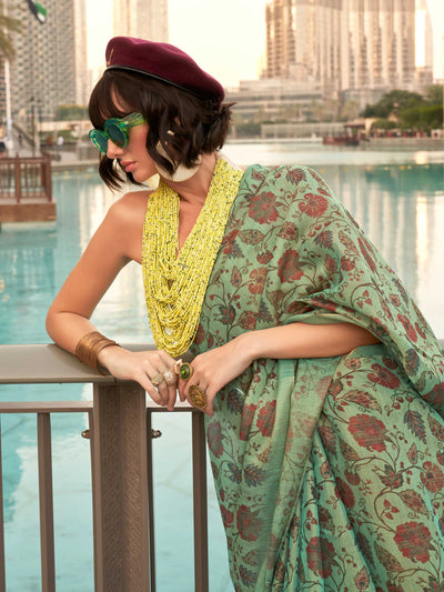 Sea Green and Golden zari tissue saree with printed floral motifs and zari pallu This image captures the model styling perspective with complete saree ensemble displayed, ideal for visualizing festive elegance, designer appeal, and modern styling inspiration. Perfect for online shoppers seeking detailed previews before purchase, enhancing saree visual merchandising and SEO-rich product display strategy.                                                                                                          