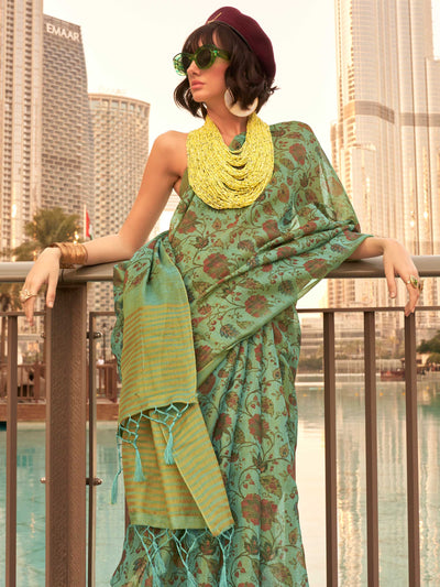 Sea Green and Golden zari tissue saree with printed floral motifs and zari pallu This image captures the side angle view showcasing blouse styling and zari border detail, ideal for visualizing festive elegance, designer appeal, and modern styling inspiration. Perfect for online shoppers seeking detailed previews before purchase, enhancing saree visual merchandising and SEO-rich product display strategy.                                                                                                          