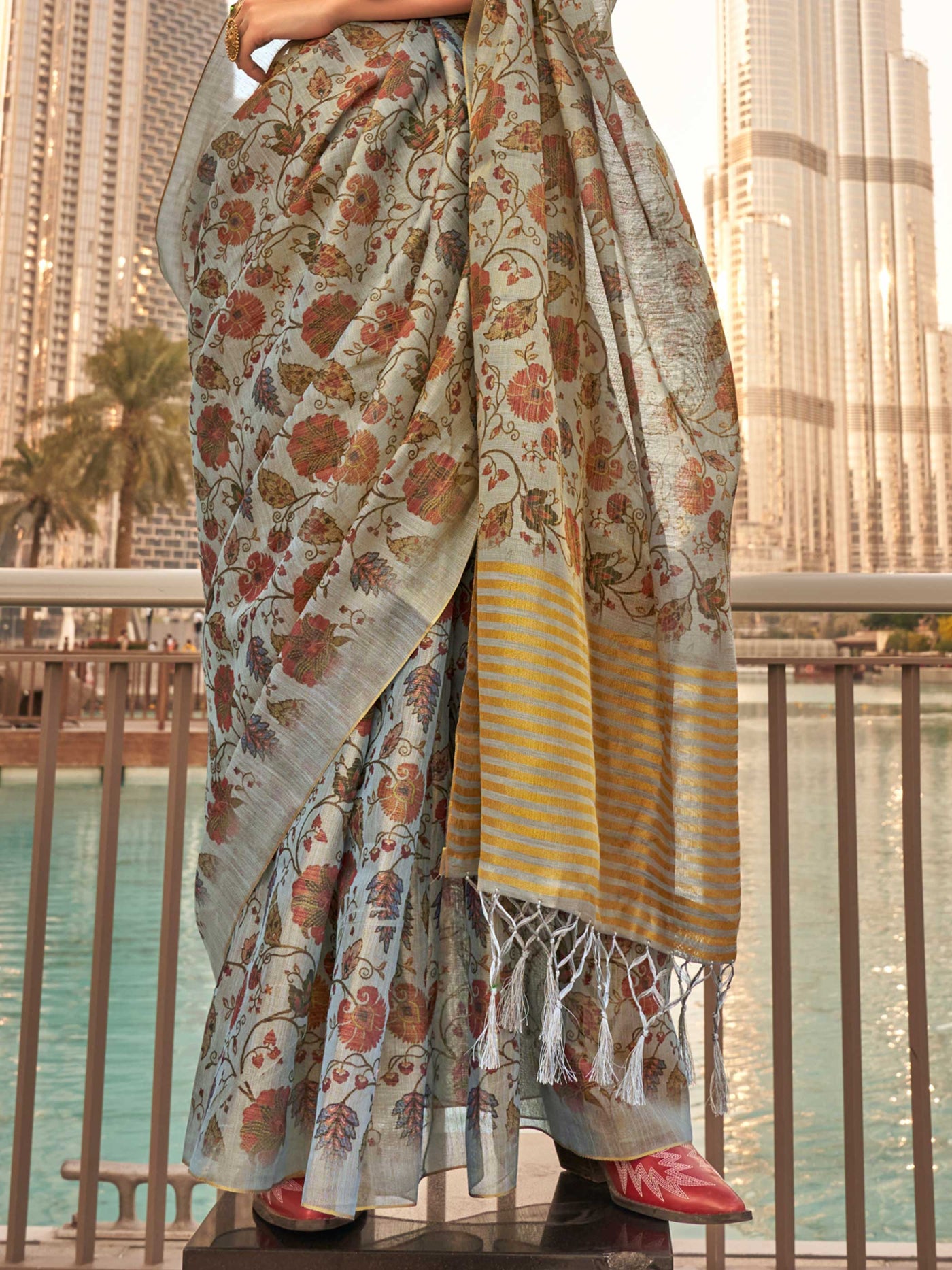 Powder Blue and Ivory zari tissue saree with printed floral motifs and zari pallu This image captures the back drape focus revealing pallu finesse and motif richness, ideal for visualizing festive elegance, designer appeal, and modern styling inspiration. Perfect for online shoppers seeking detailed previews before purchase, enhancing saree visual merchandising and SEO-rich product display strategy.                                                                                                              