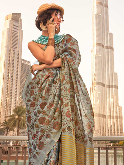 Powder Blue and Ivory zari tissue saree with printed floral motifs and zari pallu This image captures the side angle view showcasing blouse styling and zari border detail, ideal for visualizing festive elegance, designer appeal, and modern styling inspiration. Perfect for online shoppers seeking detailed previews before purchase, enhancing saree visual merchandising and SEO-rich product display strategy.                                                                                                         
