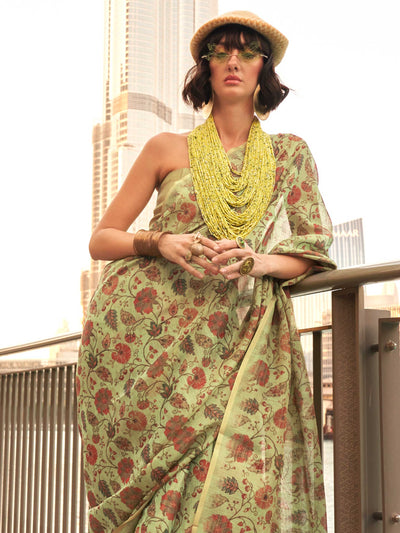 Olive Green and Mustard zari tissue saree with printed floral motifs and zari pallu This image captures the side angle view showcasing blouse styling and zari border detail, ideal for visualizing festive elegance, designer appeal, and modern styling inspiration. Perfect for online shoppers seeking detailed previews before purchase, enhancing saree visual merchandising and SEO-rich product display strategy.                                                                                                       