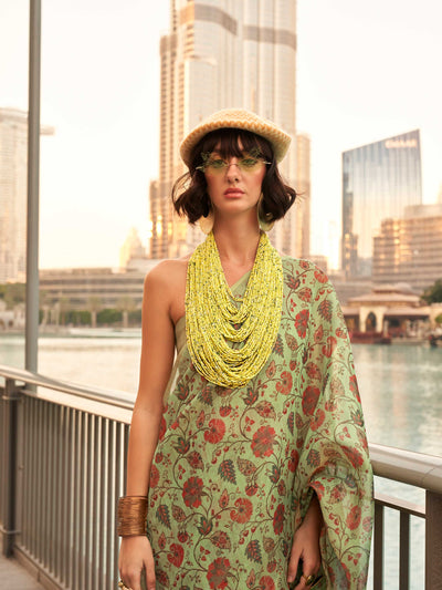 Olive Green and Mustard zari tissue saree with printed floral motifs and zari pallu This image captures the model styling perspective with complete saree ensemble displayed, ideal for visualizing festive elegance, designer appeal, and modern styling inspiration. Perfect for online shoppers seeking detailed previews before purchase, enhancing saree visual merchandising and SEO-rich product display strategy.                                                                                                       