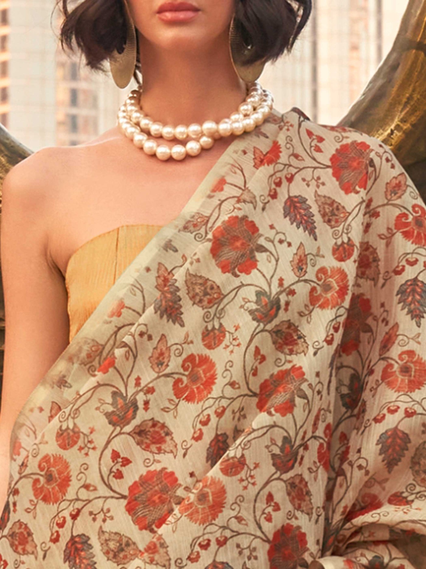 Beige and Golden zari tissue saree with printed floral motifs and zari pallu This image captures the zoomed texture view illustrating fabric weave and print clarity, ideal for visualizing festive elegance, designer appeal, and modern styling inspiration. Perfect for online shoppers seeking detailed previews before purchase, enhancing saree visual merchandising and SEO-rich product display strategy.                                                                                                               