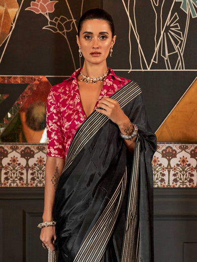 This elegant saree features a subtle all-over zari weave that sparkles under soft lighting, ideal for formal celebrations and festive occasions