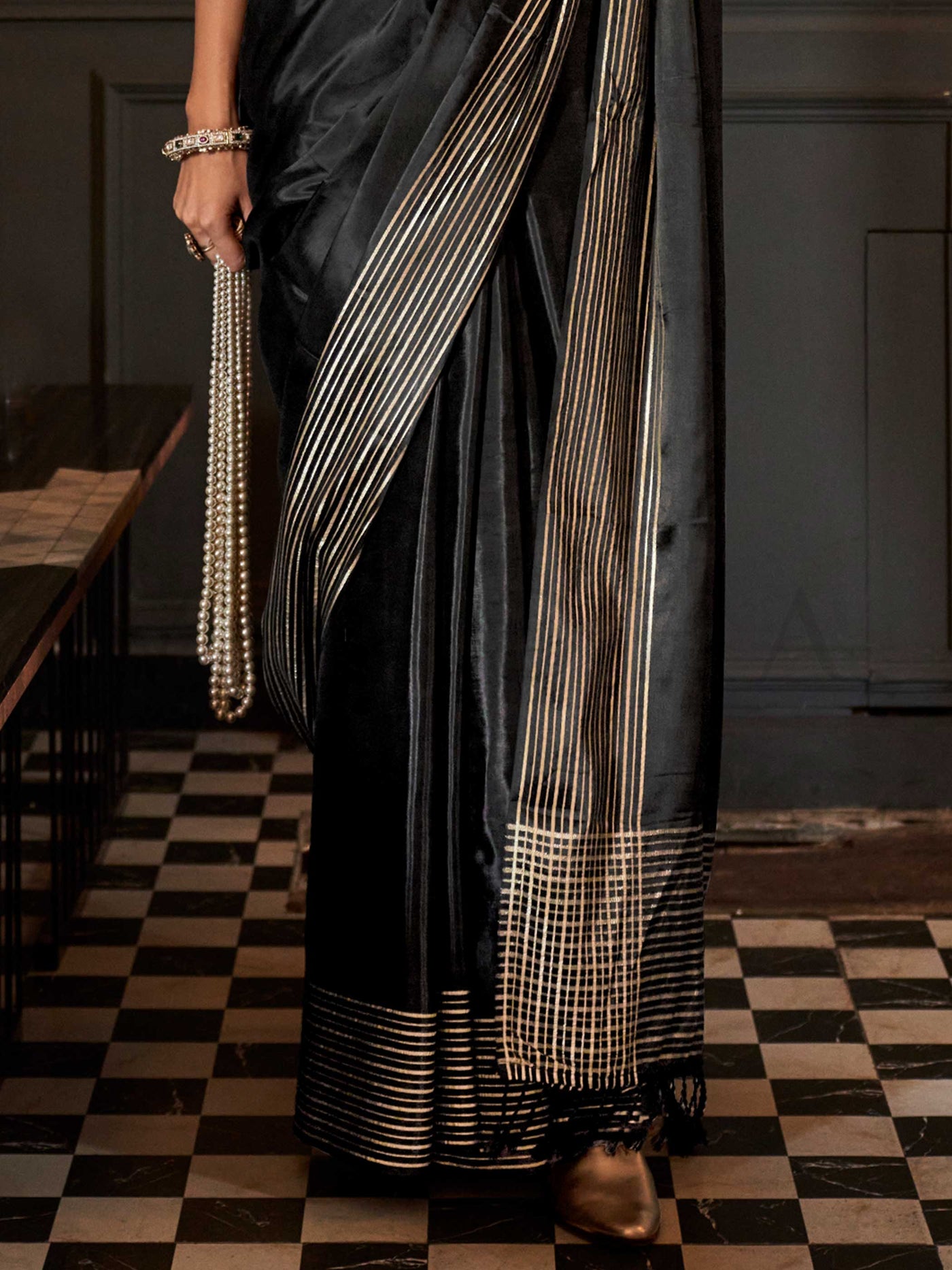 The main body of the saree has a fluid, breathable drape while the borders are defined with minimalist zari striping
