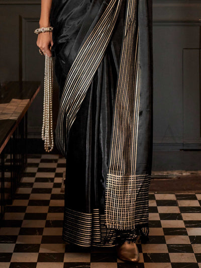 The main body of the saree has a fluid, breathable drape while the borders are defined with minimalist zari striping