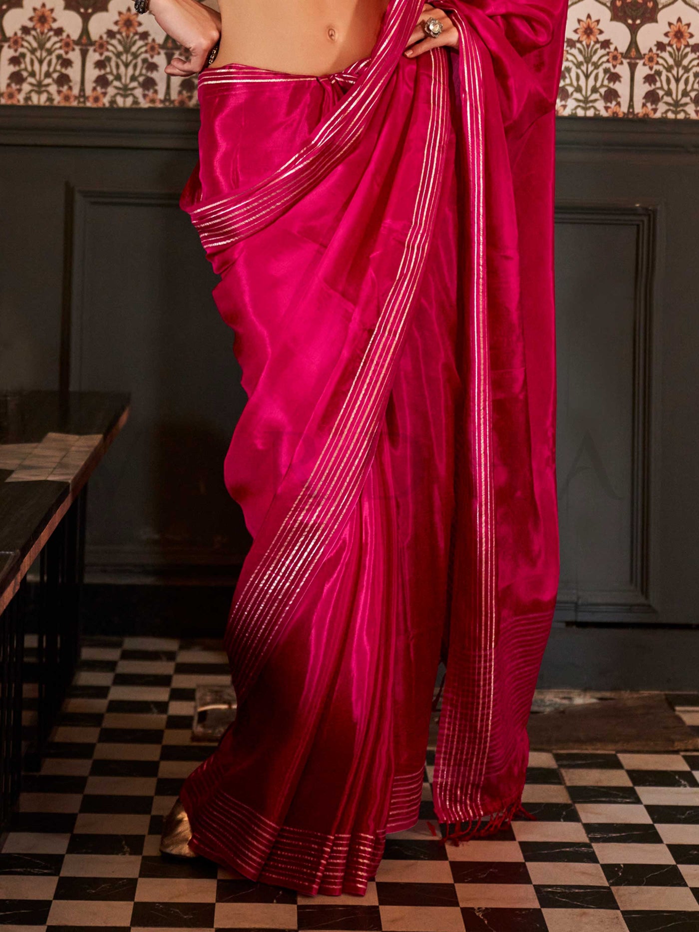 Photographed in a neutral studio with ambient shadows to highlight the zari’s glimmer and the weave’s detail