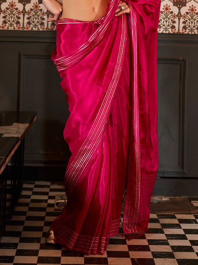 Photographed in a neutral studio with ambient shadows to highlight the zari’s glimmer and the weave’s detail