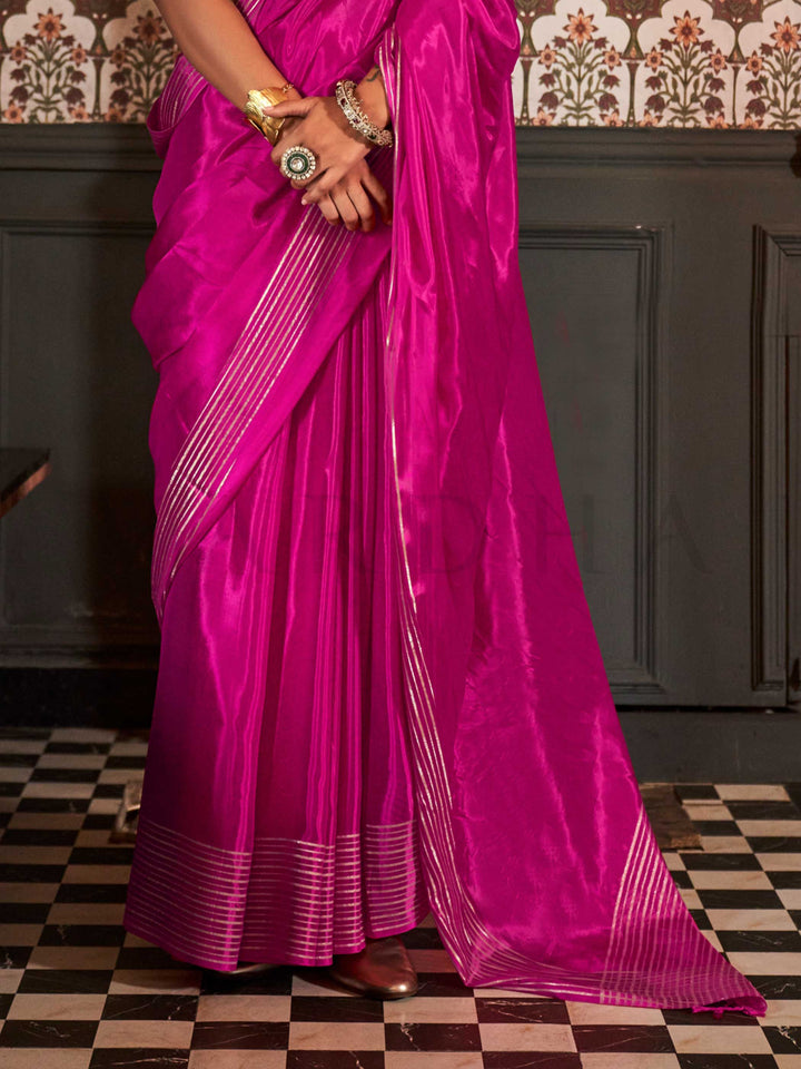This elegant saree features a subtle all-over zari weave that sparkles under soft lighting, ideal for formal celebrations and festive occasions