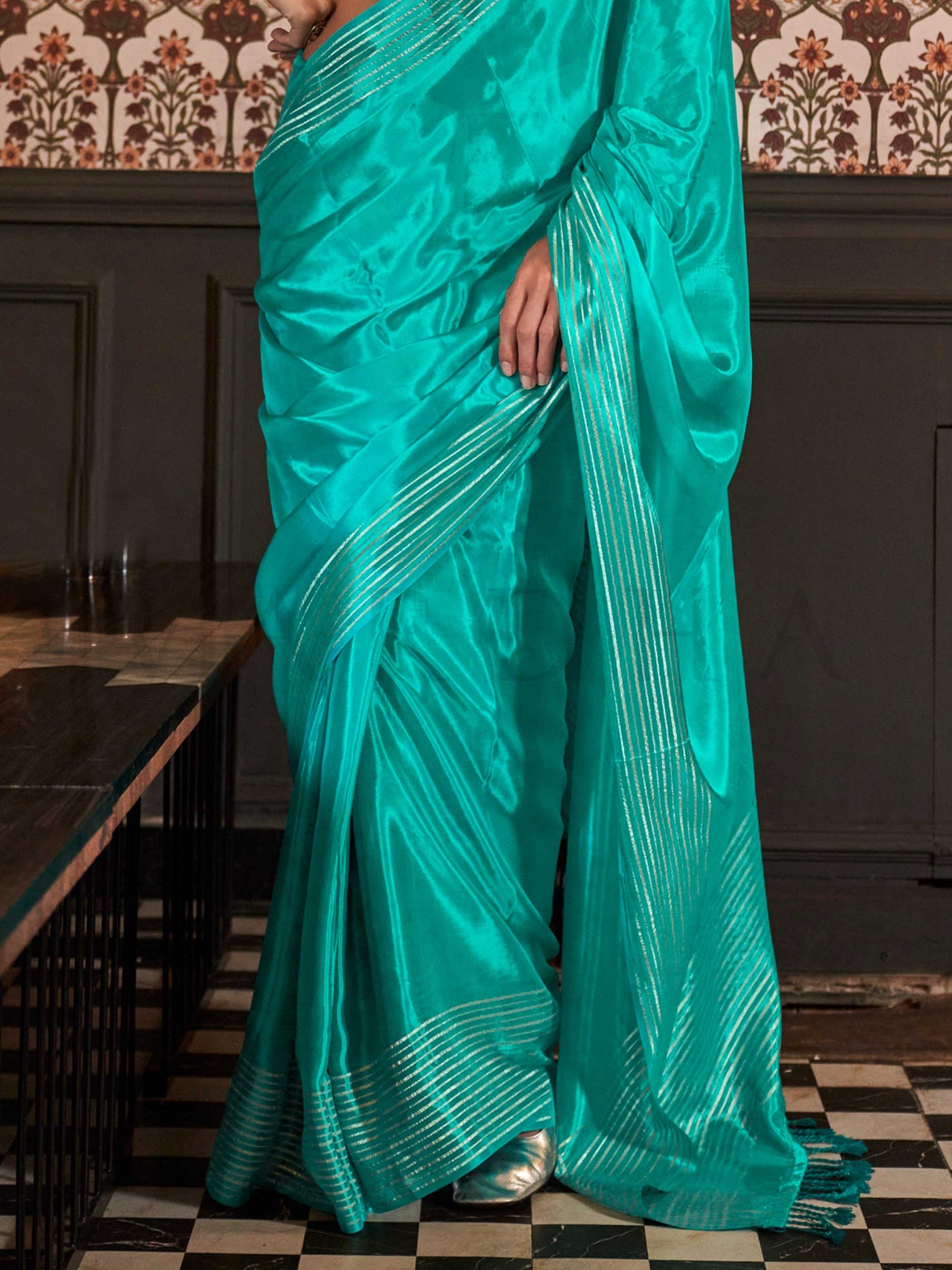Photographed in a neutral studio with ambient shadows to highlight the zari’s glimmer and the weave’s detail
