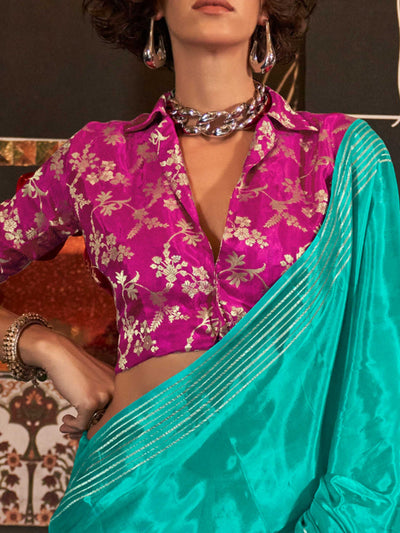 This saree pairs well with metallic jewelry and soft curls or a sleek bun