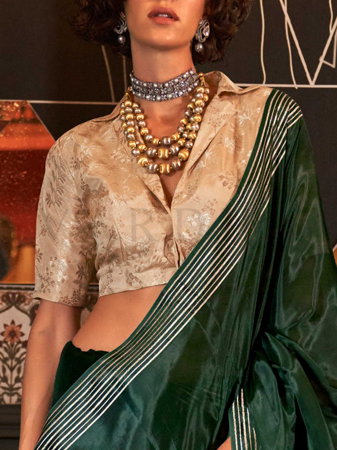 This saree pairs well with metallic jewelry and soft curls or a sleek bun