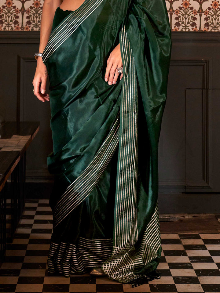 Photographed in a neutral studio with ambient shadows to highlight the zari’s glimmer and the weave’s detail