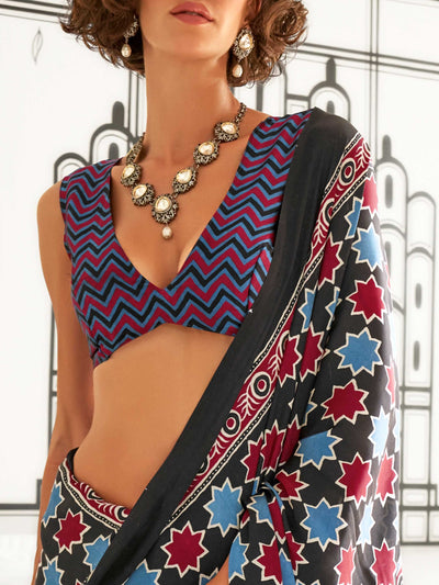 Black and Blue-Red satin crepe saree with ajrakh digital print, soft texture and festive drape This image captures the zoomed texture view illustrating fabric weave and print clarity, ideal for visualizing festive elegance, designer appeal, and modern styling inspiration. Perfect for online shoppers seeking detailed previews before purchase, enhancing saree visual merchandising and SEO-rich product display strategy.                                                                                             