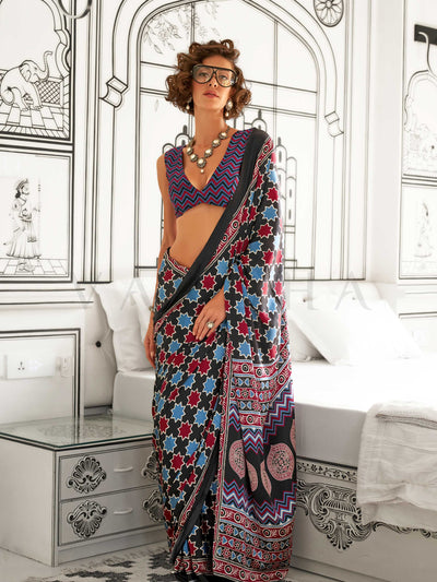 Black and Blue-Red satin crepe saree with ajrakh digital print, soft texture and festive drape This image captures the front drape view highlighting pallu fall and pleats alignment, ideal for visualizing festive elegance, designer appeal, and modern styling inspiration. Perfect for online shoppers seeking detailed previews before purchase, enhancing saree visual merchandising and SEO-rich product display strategy.                                                                                               