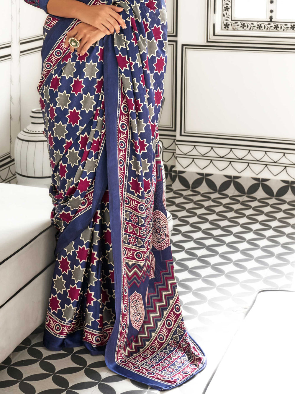 Navy Blue and Red-Ivory satin crepe saree with ajrakh digital print, soft texture and festive drape This image captures the side angle view showcasing blouse styling and zari border detail, ideal for visualizing festive elegance, designer appeal, and modern styling inspiration. Perfect for online shoppers seeking detailed previews before purchase, enhancing saree visual merchandising and SEO-rich product display strategy.                                                                                       
