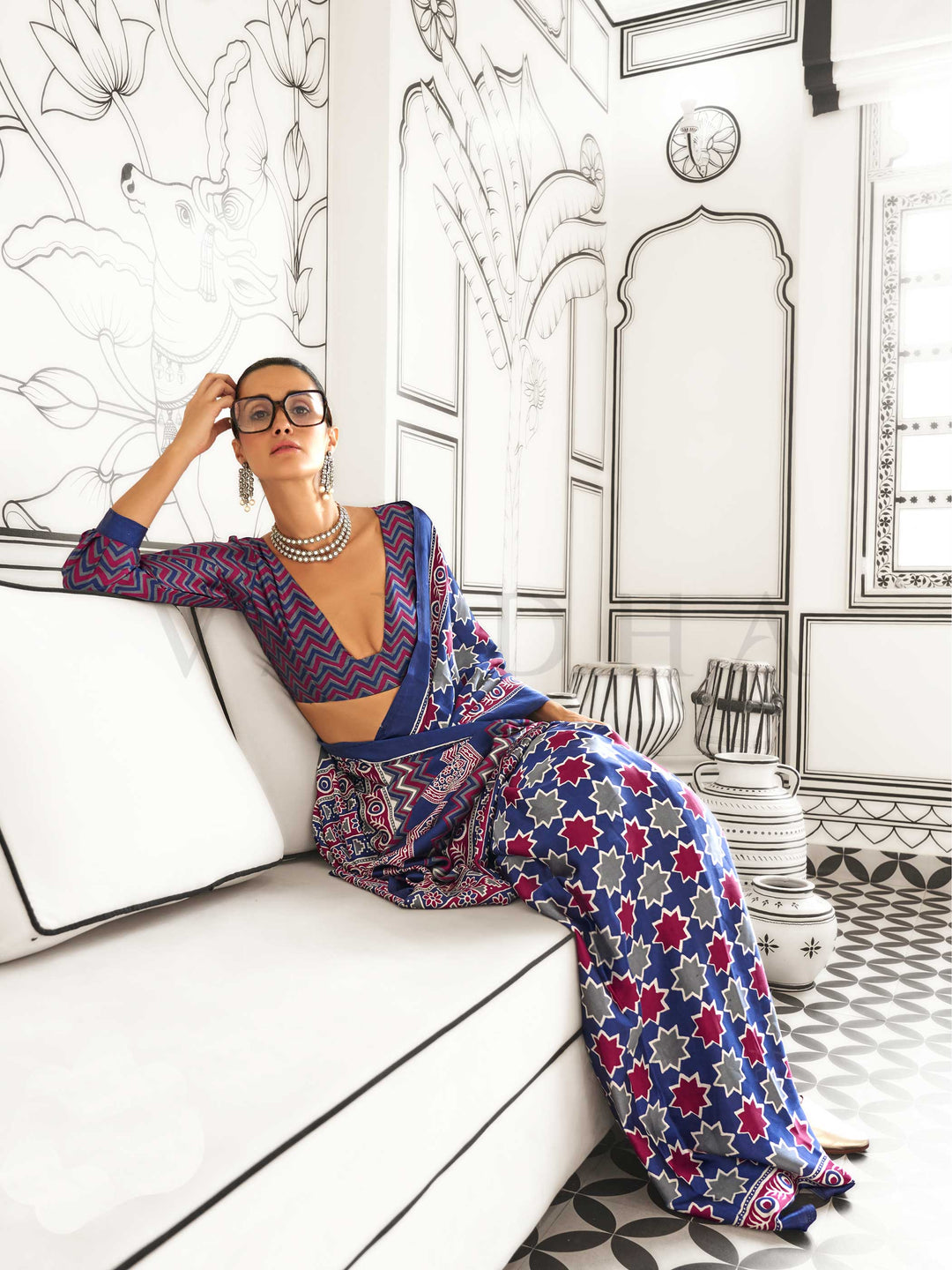 Navy Blue and Red-Ivory satin crepe saree with ajrakh digital print, soft texture and festive drape This image captures the model styling perspective with complete saree ensemble displayed, ideal for visualizing festive elegance, designer appeal, and modern styling inspiration. Perfect for online shoppers seeking detailed previews before purchase, enhancing saree visual merchandising and SEO-rich product display strategy.                                                                                       