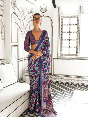 Navy Blue and Red-Ivory satin crepe saree with ajrakh digital print, soft texture and festive drape This image captures the front drape view highlighting pallu fall and pleats alignment, ideal for visualizing festive elegance, designer appeal, and modern styling inspiration. Perfect for online shoppers seeking detailed previews before purchase, enhancing saree visual merchandising and SEO-rich product display strategy.                                                                                          