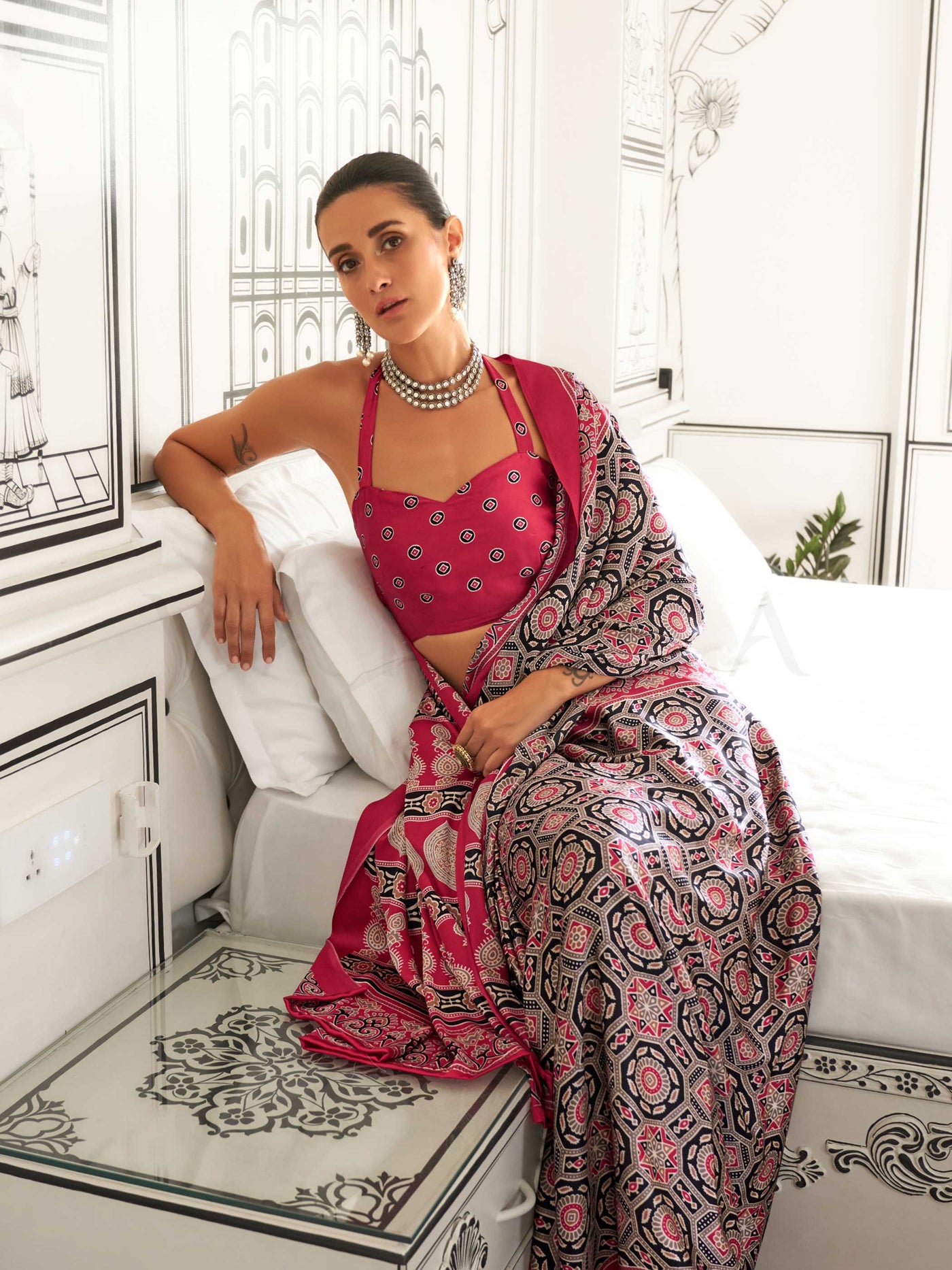 Red and Black-White satin crepe saree with ajrakh digital print, soft texture and festive drape This image captures the model styling perspective with complete saree ensemble displayed, ideal for visualizing festive elegance, designer appeal, and modern styling inspiration. Perfect for online shoppers seeking detailed previews before purchase, enhancing saree visual merchandising and SEO-rich product display strategy.                                                                                           