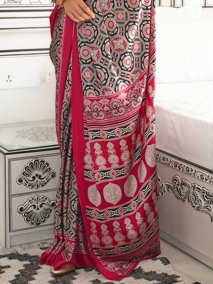 Red and Black-White satin crepe saree with ajrakh digital print, soft texture and festive drape This image captures the back drape focus revealing pallu finesse and motif richness, ideal for visualizing festive elegance, designer appeal, and modern styling inspiration. Perfect for online shoppers seeking detailed previews before purchase, enhancing saree visual merchandising and SEO-rich product display strategy.                                                                                                