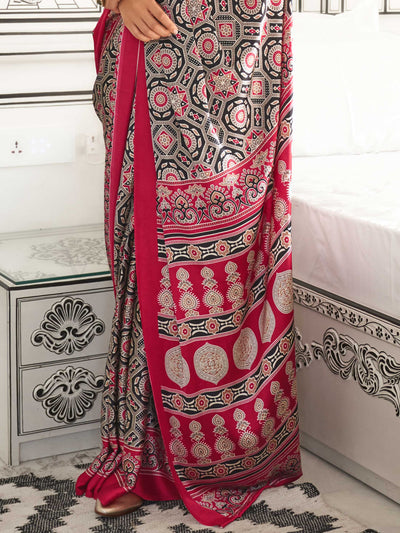 Red and Black-White satin crepe saree with ajrakh digital print, soft texture and festive drape This image captures the back drape focus revealing pallu finesse and motif richness, ideal for visualizing festive elegance, designer appeal, and modern styling inspiration. Perfect for online shoppers seeking detailed previews before purchase, enhancing saree visual merchandising and SEO-rich product display strategy.                                                                                                