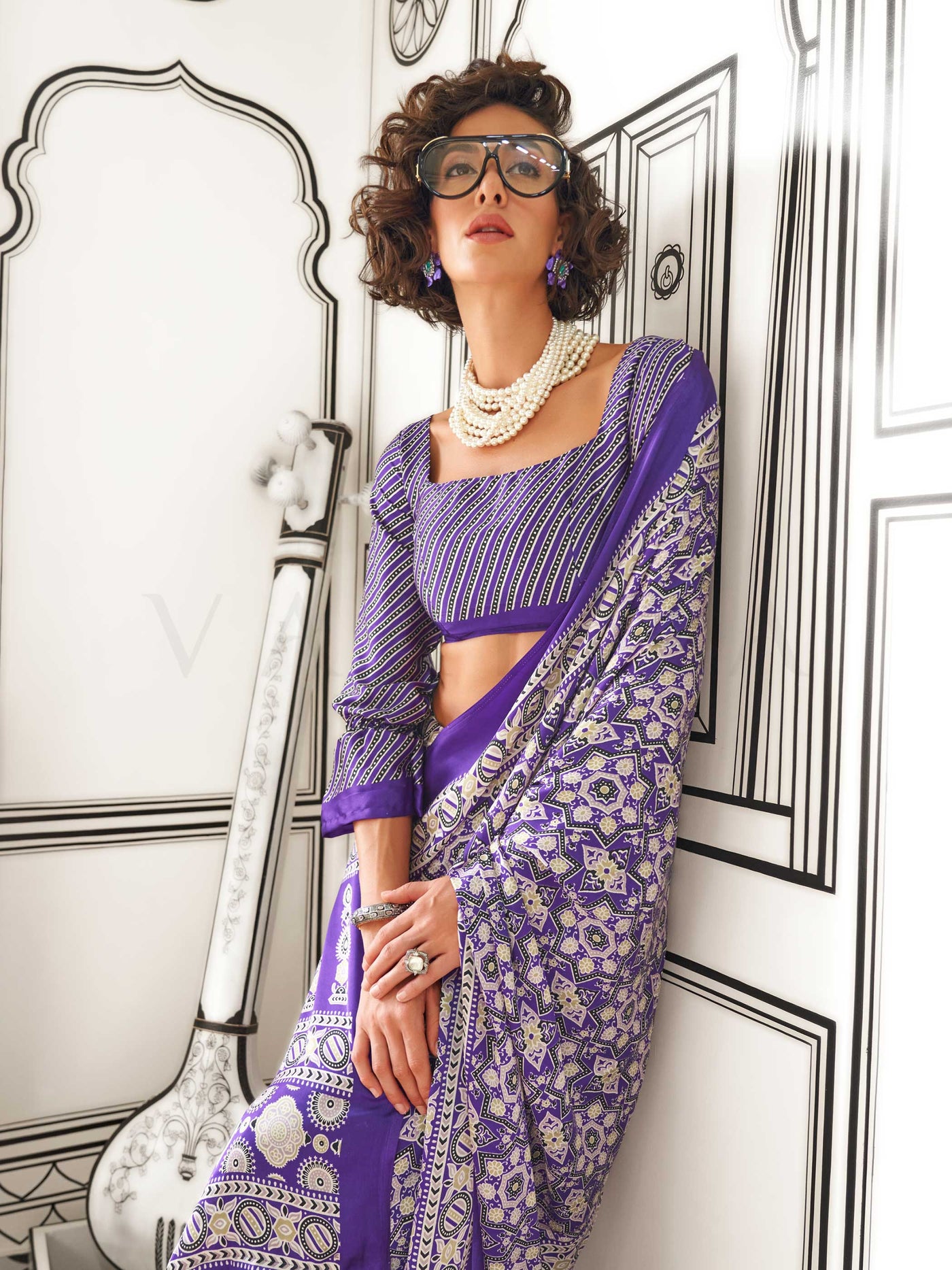 Purple and Silver satin crepe saree with ajrakh digital print, soft texture and festive drape This image captures the model styling perspective with complete saree ensemble displayed, ideal for visualizing festive elegance, designer appeal, and modern styling inspiration. Perfect for online shoppers seeking detailed previews before purchase, enhancing saree visual merchandising and SEO-rich product display strategy.                                                                                             