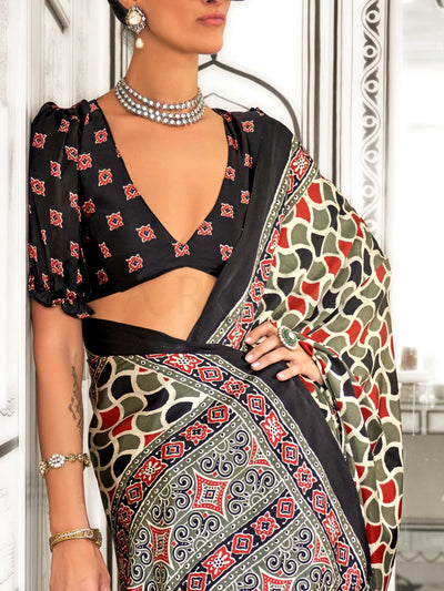 Black and Olive-Red satin crepe saree with ajrakh digital print, soft texture and festive drape This image captures the side angle view showcasing blouse styling and zari border detail, ideal for visualizing festive elegance, designer appeal, and modern styling inspiration. Perfect for online shoppers seeking detailed previews before purchase, enhancing saree visual merchandising and SEO-rich product display strategy.                                                                                           