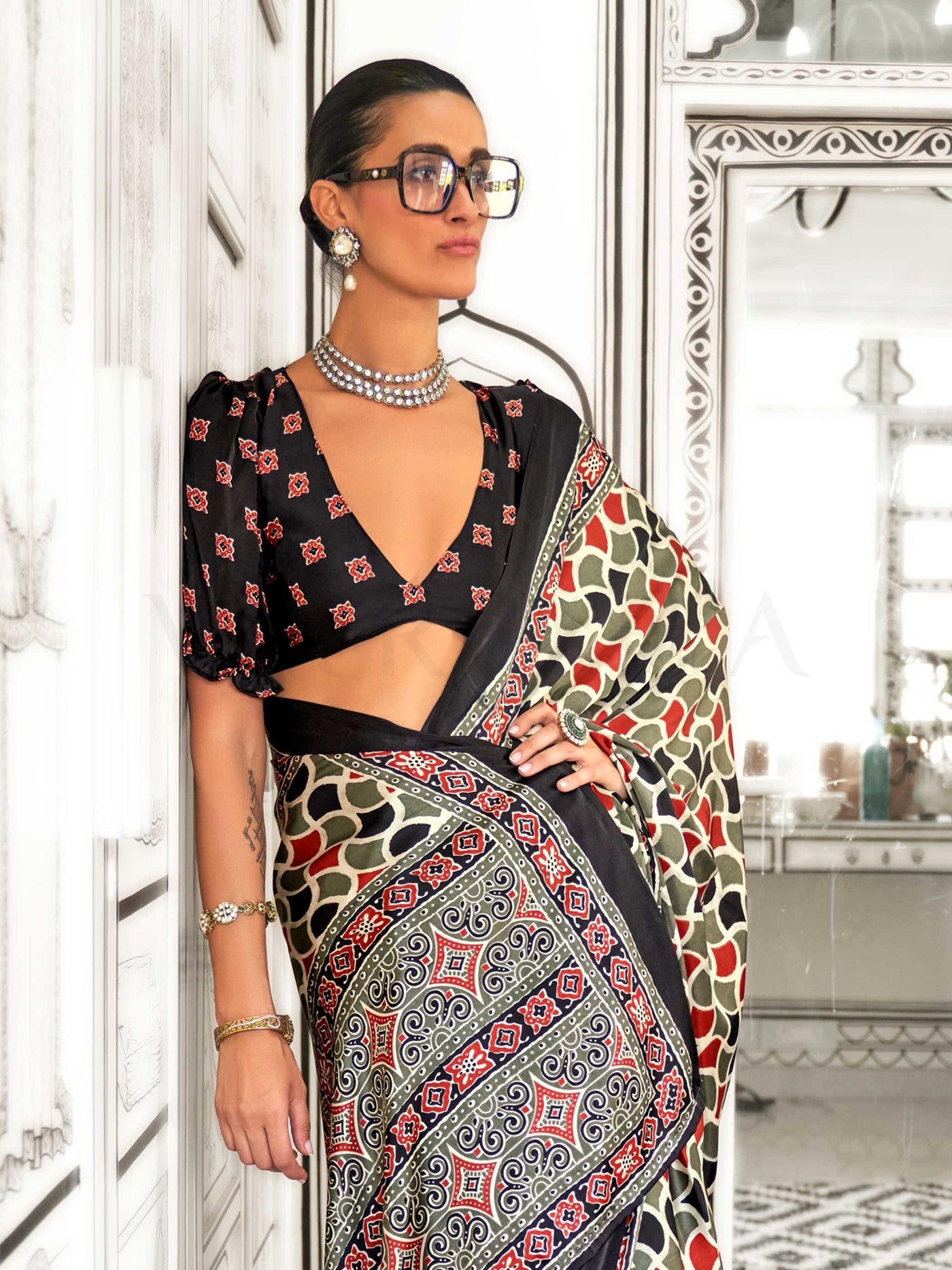 Black and Olive-Red satin crepe saree with ajrakh digital print, soft texture and festive drape This image captures the zoomed texture view illustrating fabric weave and print clarity, ideal for visualizing festive elegance, designer appeal, and modern styling inspiration. Perfect for online shoppers seeking detailed previews before purchase, enhancing saree visual merchandising and SEO-rich product display strategy.                                                                                            