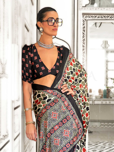 Black and Olive-Red satin crepe saree with ajrakh digital print, soft texture and festive drape This image captures the zoomed texture view illustrating fabric weave and print clarity, ideal for visualizing festive elegance, designer appeal, and modern styling inspiration. Perfect for online shoppers seeking detailed previews before purchase, enhancing saree visual merchandising and SEO-rich product display strategy.                                                                                            