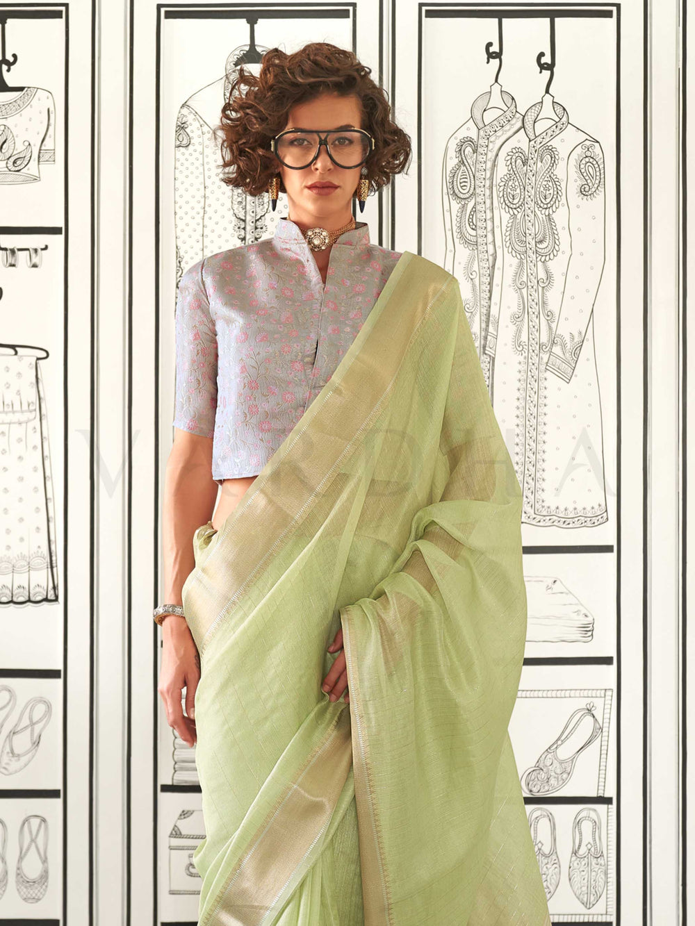 Pista Green moss chiffon saree styled for front profile This image captures the side angle view showcasing blouse styling and zari border detail, ideal for visualizing festive elegance, designer appeal, and modern styling inspiration. Perfect for online shoppers seeking detailed previews before purchase, enhancing saree visual merchandising and SEO-rich product display strategy.                                                                                                                                   