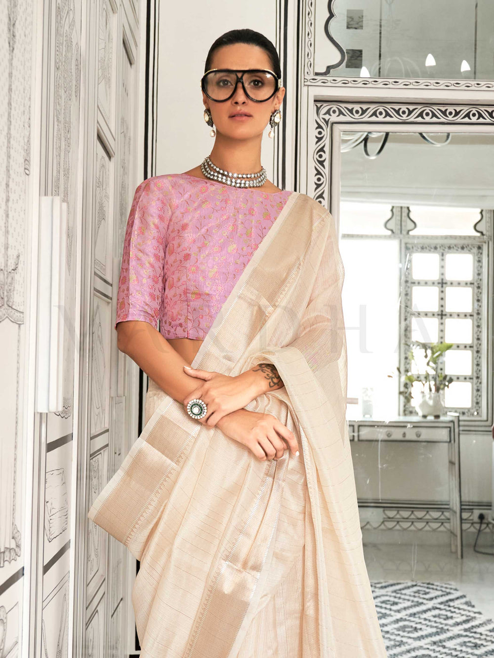 Ivory moss chiffon saree styled for front profile This image captures the side angle view showcasing blouse styling and zari border detail, ideal for visualizing festive elegance, designer appeal, and modern styling inspiration. Perfect for online shoppers seeking detailed previews before purchase, enhancing saree visual merchandising and SEO-rich product display strategy.                                                                                                                                         