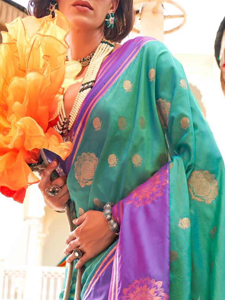 Charming Emerald Green–Purple satin saree with textured pallu and timeless weaving artistry. Traditional-meets-modern in this Emerald Green–Purple saree with zari borders and vibrant festival palette.