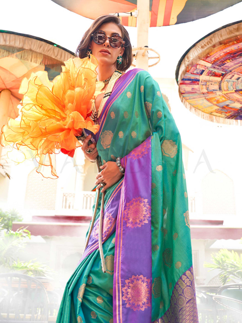 Elegant Emerald Green–Purple silk saree with jacquard weave and mandala inspired border detailing. Emerald Green–Purple saree for weddings and sangeet, finished with artistic zari craftsmanship and rich drape.